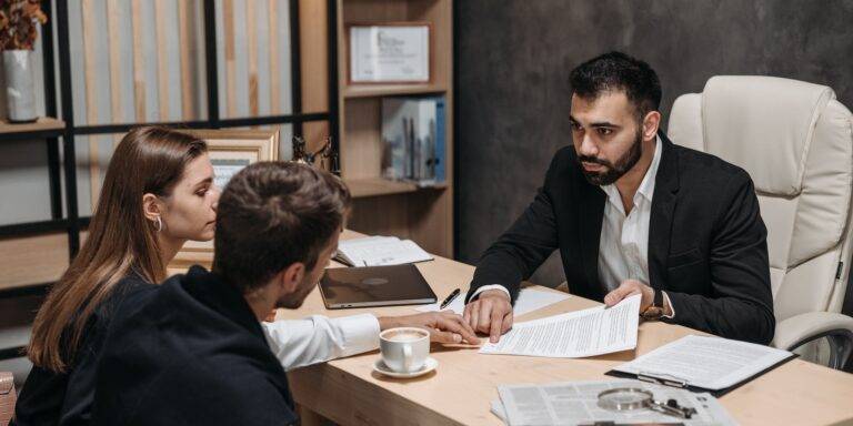 A Man in Black Suit Talking to His Clients